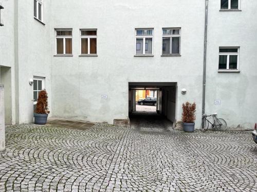 a large white building with a cobblestone courtyard at Sweet home in Ludwigsburg