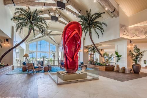 a large red sculpture in a lobby with palm trees at 2971 Castaway Lane in Orlando