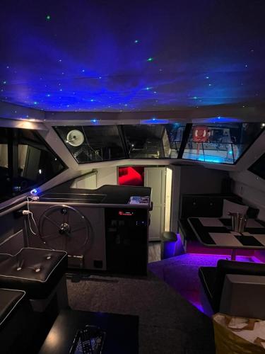 a view of the inside of a boat with purple lights at YACHT "X" - 44 FOOT MODERN YACHT ON 5 STAR OCEAN VILLAGE MARINA - minutes away from city centre and cruise terminals, Free parking ,SPA package available! in Southampton