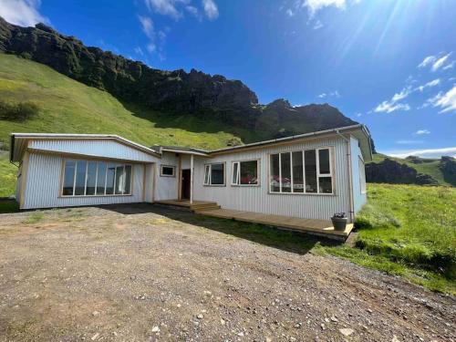 a house on a hill with a mountain at Beautiful house with an outstanding view in Hvolsvöllur