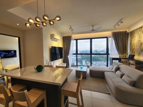 a living room with a couch and a table at Urban Suite - George Town in Jelutong