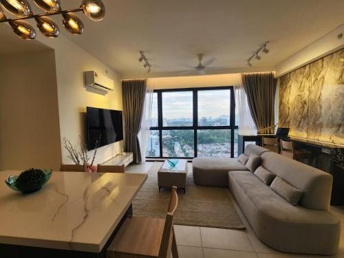 a living room with a couch and a table at Urban Suite - George Town in Jelutong