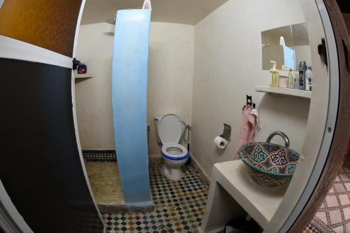 a small bathroom with a toilet and a mirror at hostel Dar belghiti in Fès
