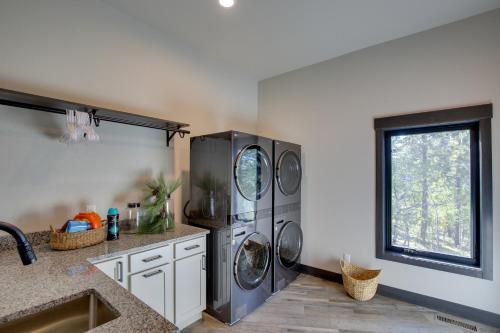 a kitchen with a washer and dryer in a room at South Dakota Retreat with Hot Tub, Fire Pit and Grill! in Spearfish