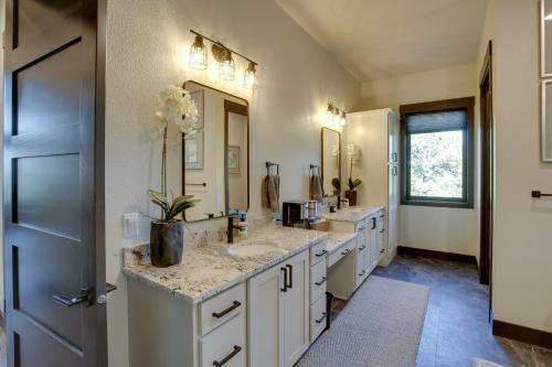 a bathroom with two sinks and a large mirror at South Dakota Retreat with Hot Tub, Fire Pit and Grill! in Spearfish