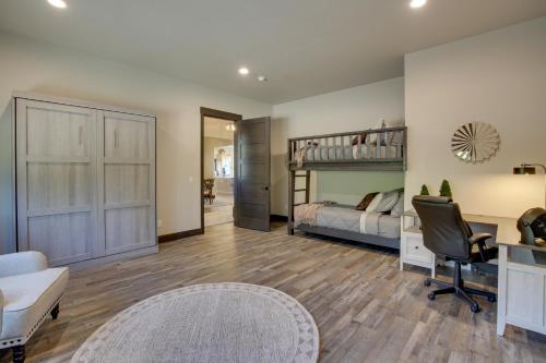 a bedroom with a bunk bed and a desk at South Dakota Retreat with Hot Tub, Fire Pit and Grill! in Spearfish