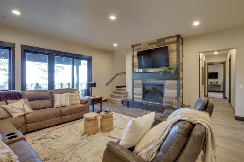 a living room with a couch and a fireplace at South Dakota Retreat with Hot Tub, Fire Pit and Grill! in Spearfish