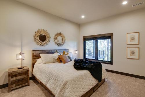a bedroom with a bed and a mirror on the wall at South Dakota Retreat with Hot Tub, Fire Pit and Grill! in Spearfish