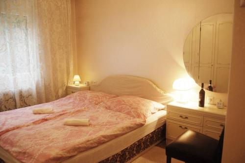 a bedroom with a bed and a dresser and a mirror at Nobel-Prize-Appartement in Graz