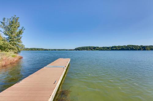 a dock on a lake with trees in the background at Jim Croces Farmhouse Apartment in Downingtown! in Downingtown