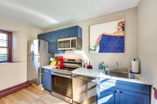 a kitchen with blue cabinets and a sink at Jim Croces Farmhouse Apartment in Downingtown! in Downingtown