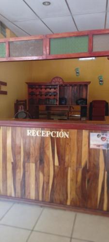 a library with a wooden counter in a room at Hostal Miraflores B&B in Santo Domingo