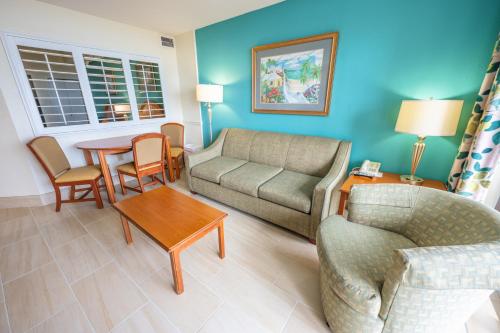 a living room with a couch and a table at Resort condo w balcony & hot tubs in Myrtle Beach