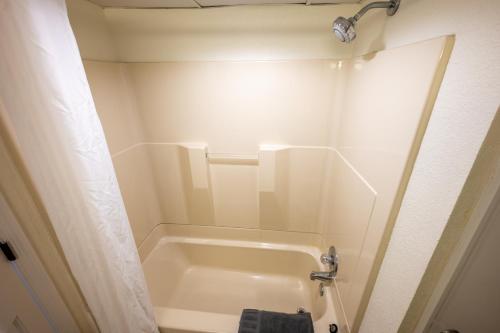 a small bathroom with a tub and a shower at Resort condo w balcony & hot tubs in Myrtle Beach
