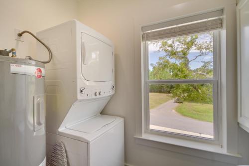a laundry room with a washing machine and a window at Waterfront Pass Christian Paradise 1 Mi to Beach in Pass Christian