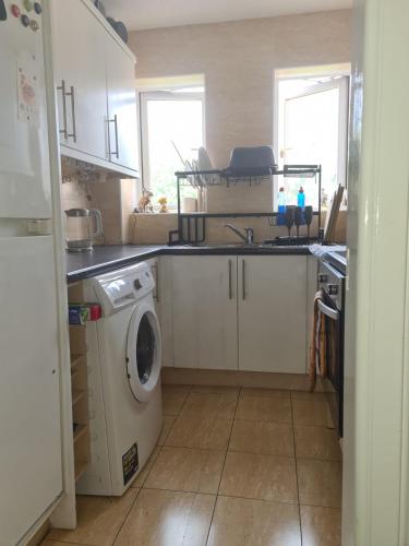 a kitchen with a sink and a washing machine at Glasgow City in Glasgow