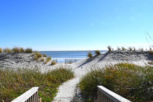a sandy path to the ocean on a beach at Resort condo w balcony & hot tubs in Myrtle Beach