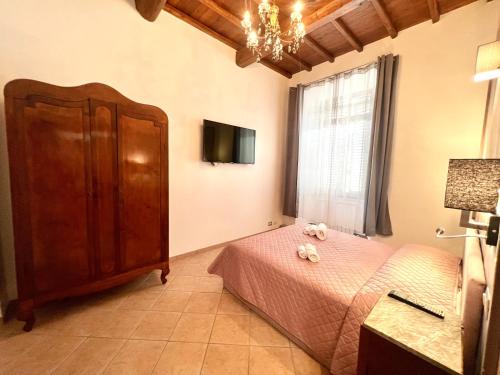 a bedroom with a bed and a dresser and a window at Sealovers house in Civitavecchia