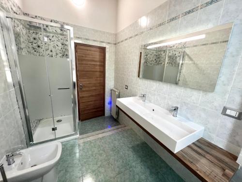a bathroom with a tub and a sink and a shower at Sealovers house in Civitavecchia