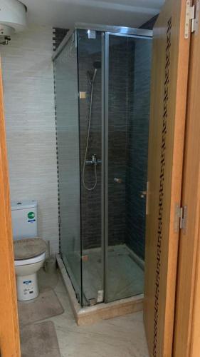 a glass shower in a bathroom with a toilet at Appartement Meublée in Casablanca