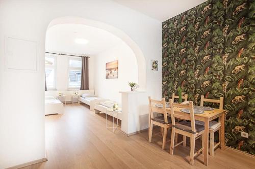a dining room with a table and a wall mural at TM Studio in Dortmund
