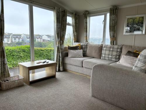a living room with a couch and a table at High View in Torquay