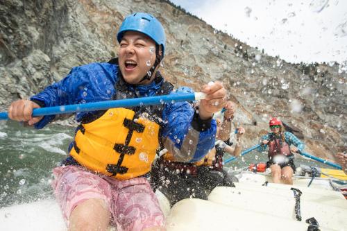 a group of people rafting down a river at Kumsheen Rafting Resort in Lytton