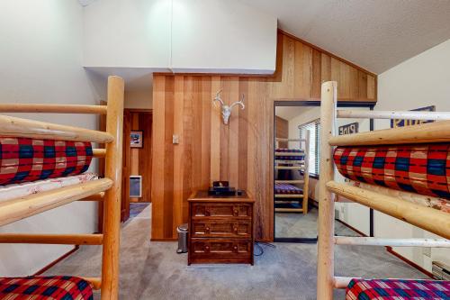 a room with three bunk beds and a desk at Meadow Ridge 34 in Mammoth Lakes