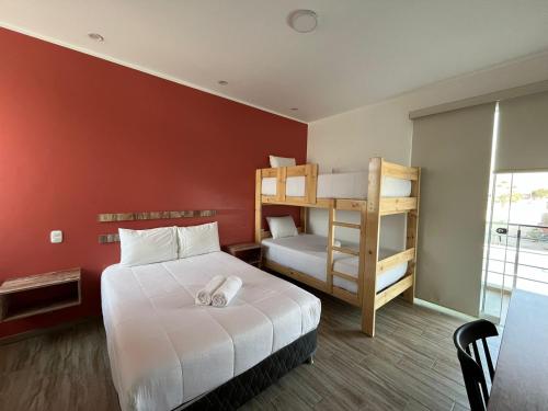 a bedroom with a bed and a bunk bed at La Estancia Hotel Ica in Ica