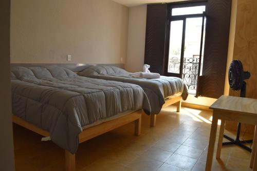 Una cama o camas en una habitación de El Suburbio - Serapio Rendon