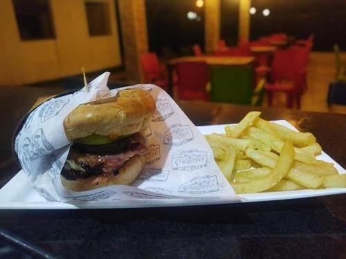 a plate with a sandwich and french fries on a table at Chiriguare parrilla in Villavicencio