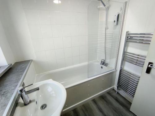 a bathroom with a sink and a tub and a toilet at Osney Willow Studio Flat - Self Contained Studio Flat in Oxford