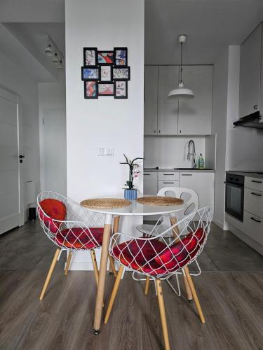 a kitchen with a table and two chairs at Studio Pieskowa Skała in Warsaw
