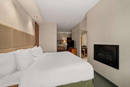 a large white bed in a hotel room at Best Western Plus Orangeville Inn & Suites in Orangeville