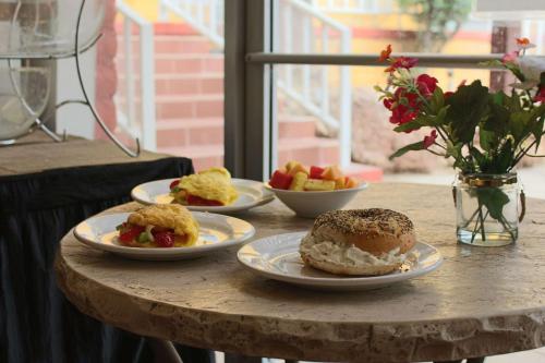 a table with three plates of food on it at Hotel Americana in Nogales