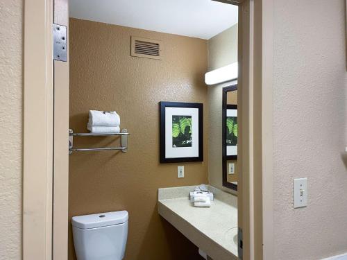 a bathroom with a toilet and a sink and a mirror at Motel 6 Columbus, GA Columbus Airport in Columbus