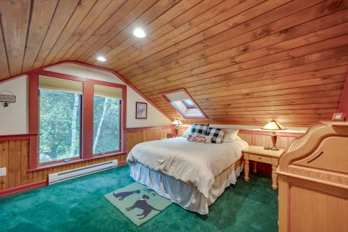 a bedroom with a bed and a wooden ceiling at Ski-in Condo with Hot Tub on Burke Mtn Slopes! in East Burke