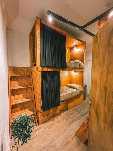 a room with two bunk beds and a ladder at Hilda House Hostel in Mar del Plata