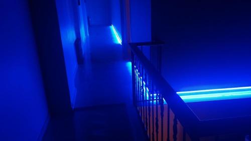 a blue light is coming down a stair case at Ada Palas Otel in Marmara Adasi