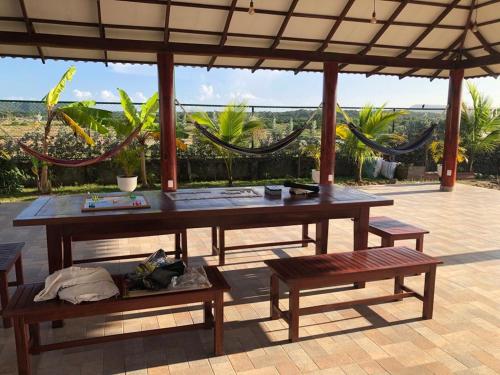 a picnic table and two benches under a pavilion at Casa Bita Morales CASA 201 in Cartagena de Indias