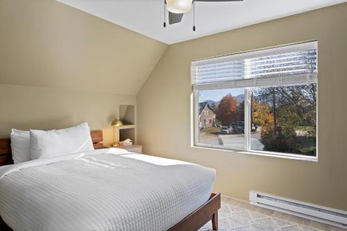 a bedroom with a bed and a large window at Modern Home &Cozy in Lake Placid