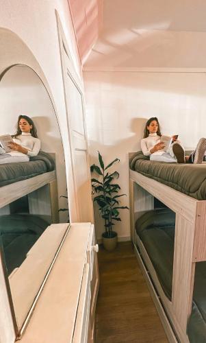 two girls sitting on bunk beds in a room at Hilda House Hostel in Mar del Plata