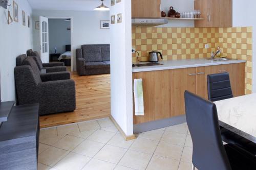 a kitchen and living room with a table and chairs at Cēsu Namiņš in Cēsis