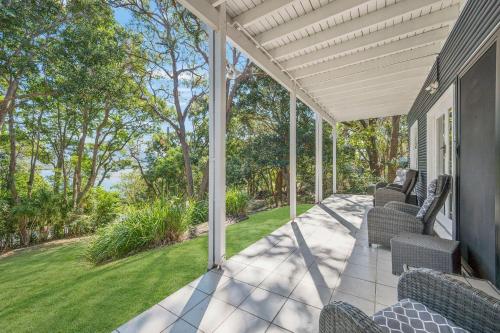 a porch with chairs on a house at Seascape in North Haven