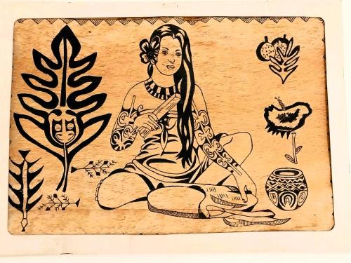 a drawing of a woman sitting on the ground with plants at TAHITI - Haumaru Beach Fare in Mahina