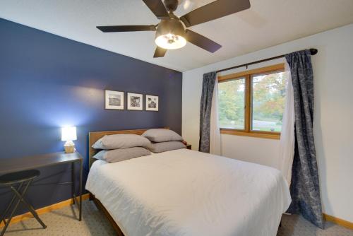 a bedroom with a bed and a ceiling fan at Hermantown Home with Decks, Grill and Hot Tub! in Hermantown