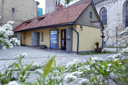 a building with a sign in front of it at Cēsu Namiņš in Cēsis