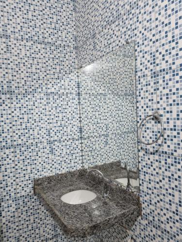 a bathroom with a sink and a mirror at Pousada Talismã in Barreirinhas