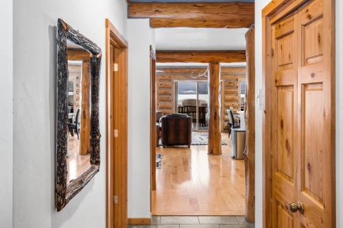 a hallway of a house with a mirror on the wall at King's Cabin in West Yellowstone