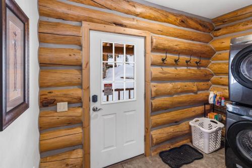 a door in a room with wooden walls at King's Cabin in West Yellowstone
